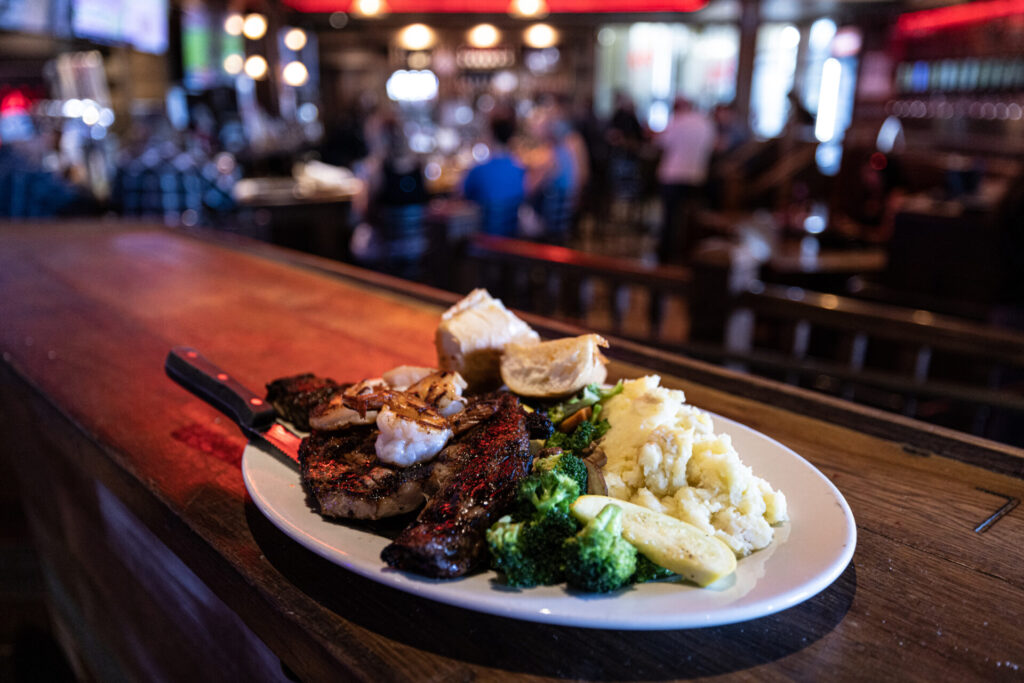 Staeak on a plate on the bar.
